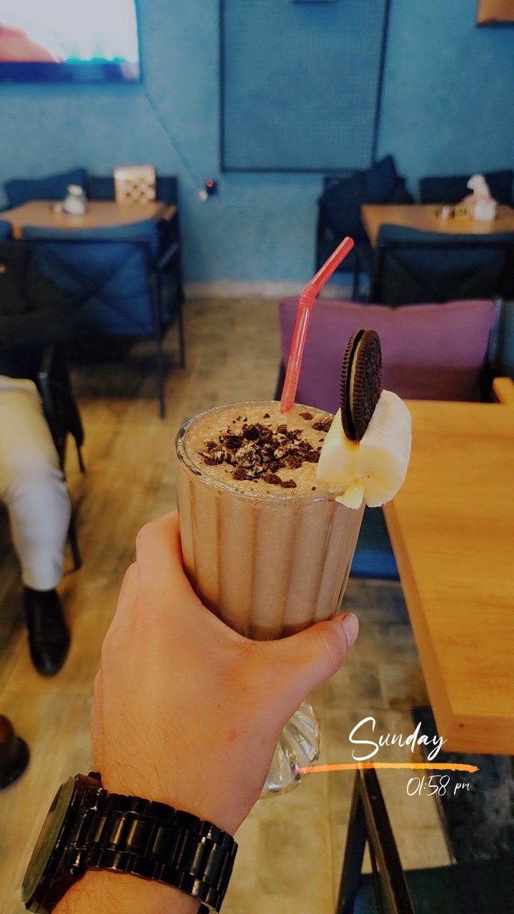 Guest holding an Oreo banana shake at Marina