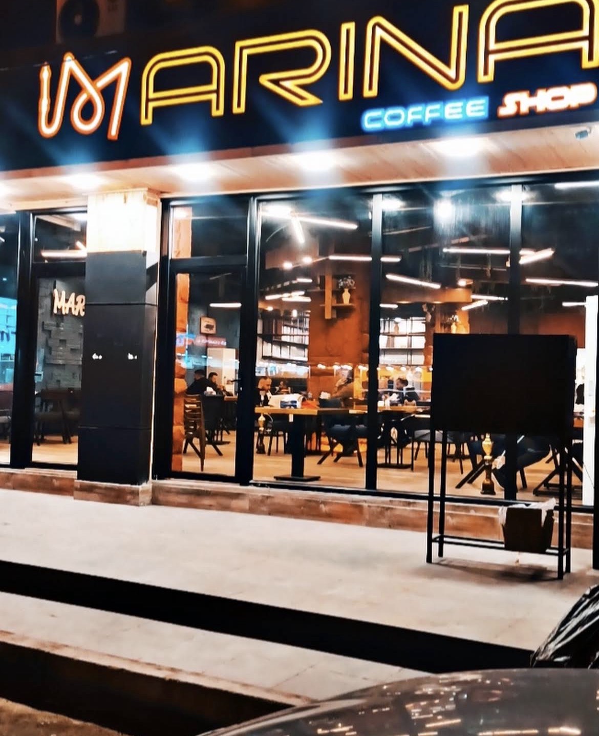 Marina Coffee Shop neon storefront at night in Duhok
